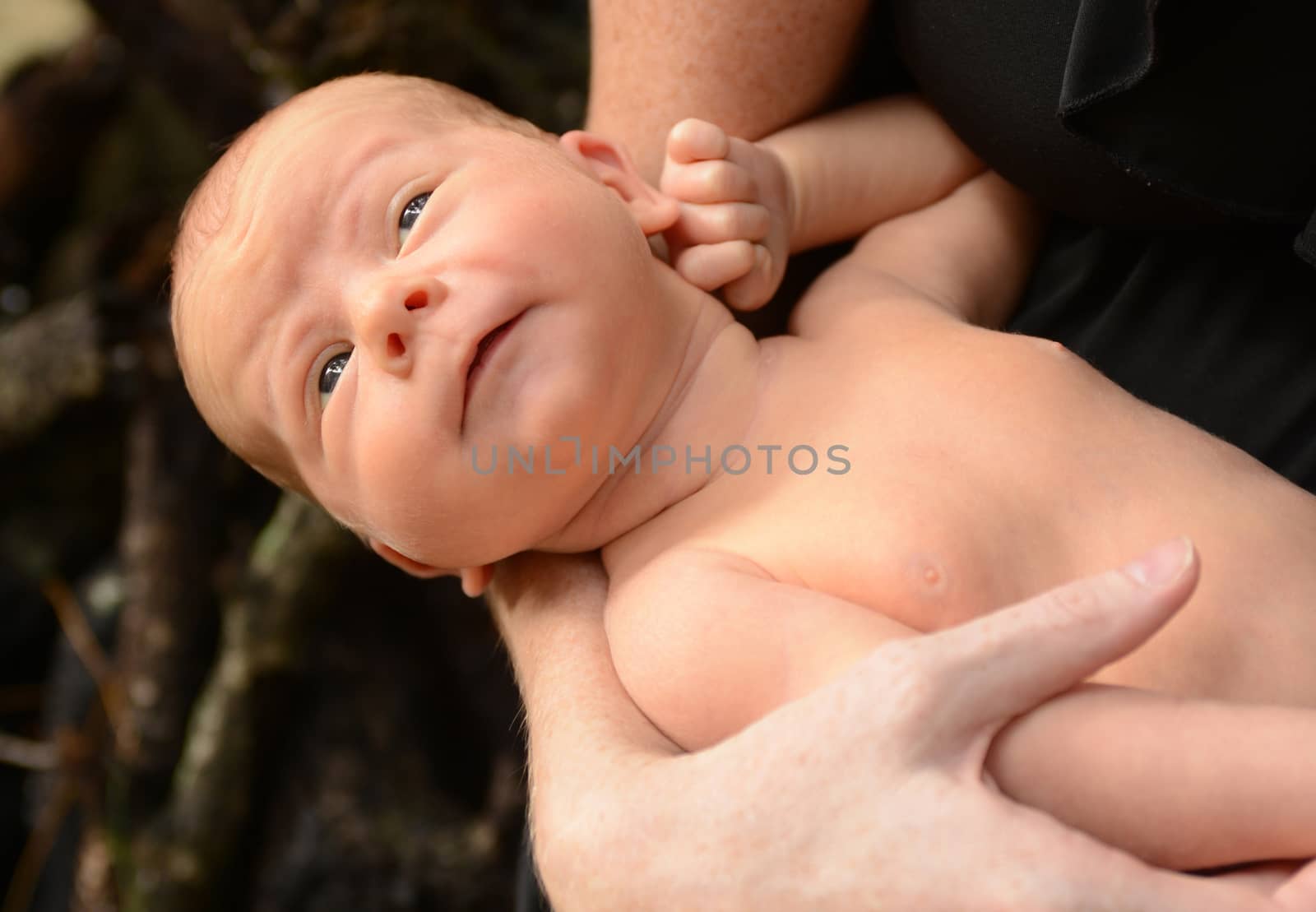 funny face on newborn infant who is looking away