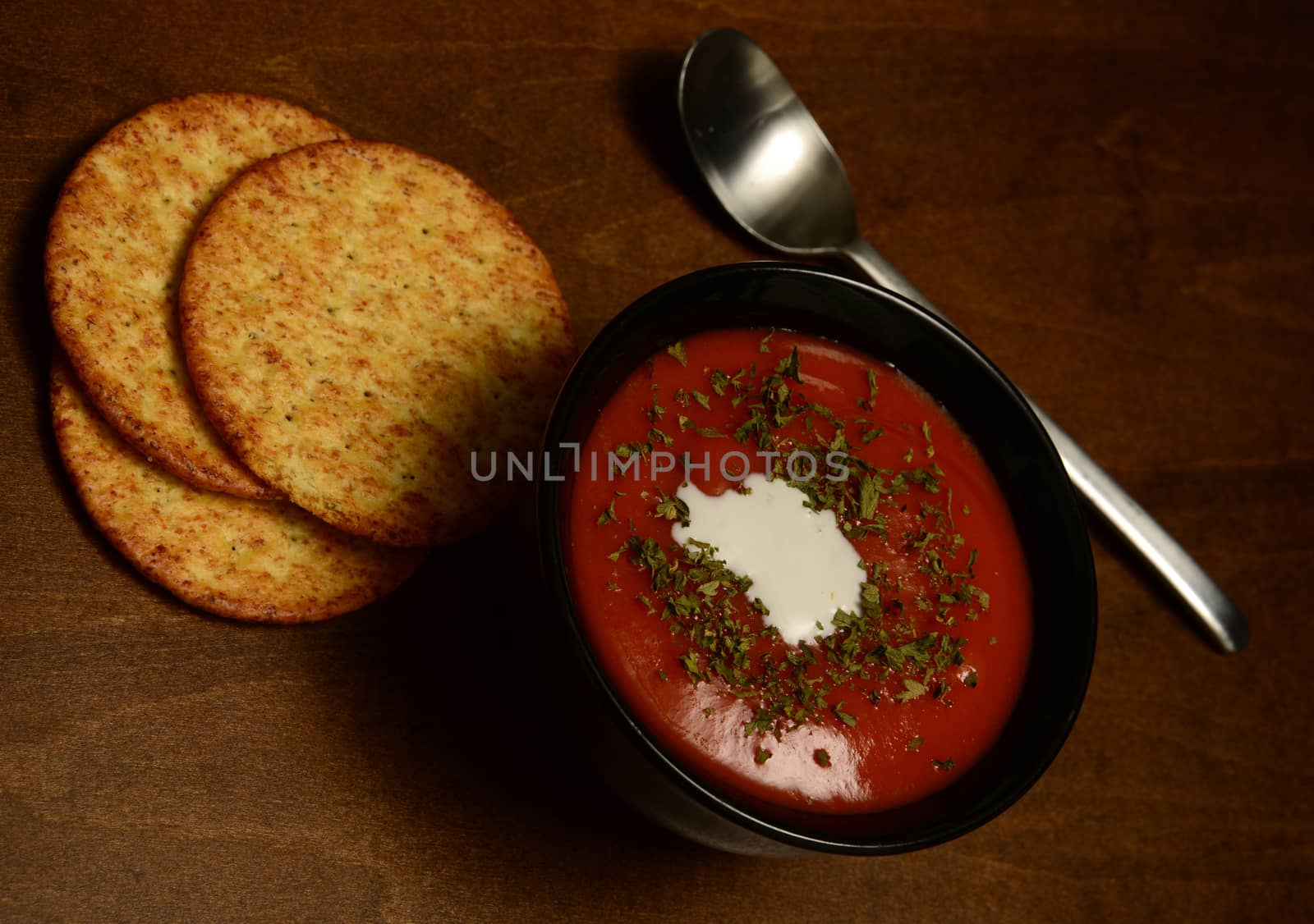 vegetarian tomato soup with crackers on country wooden table