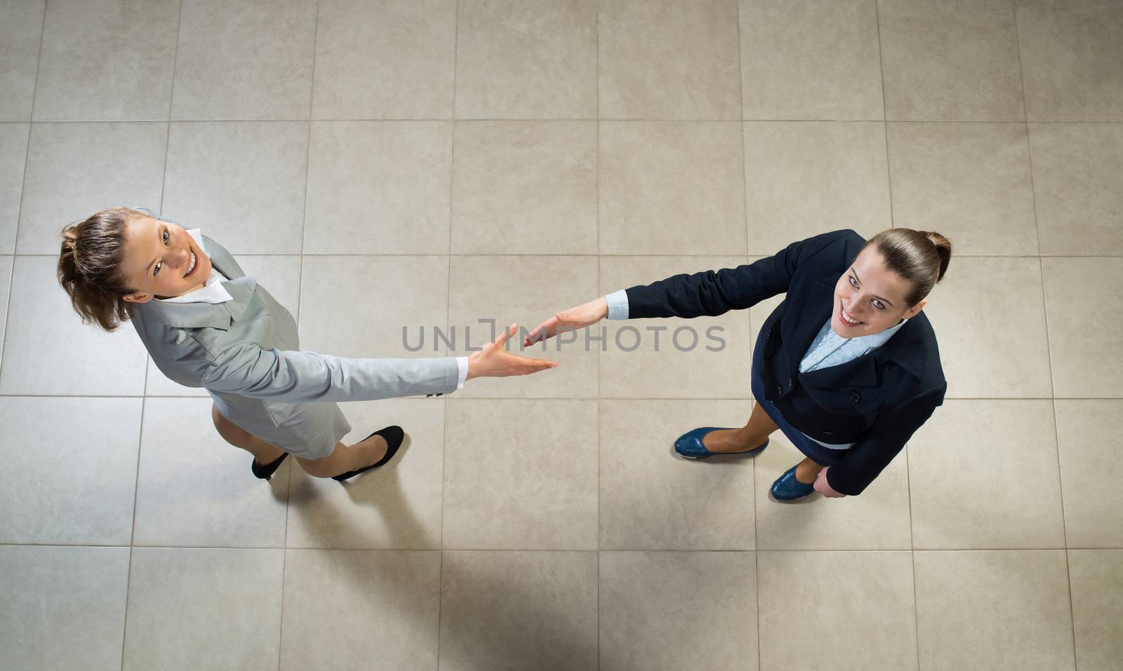 image of a businessmen stretching out their hands towards each other, the future handshake