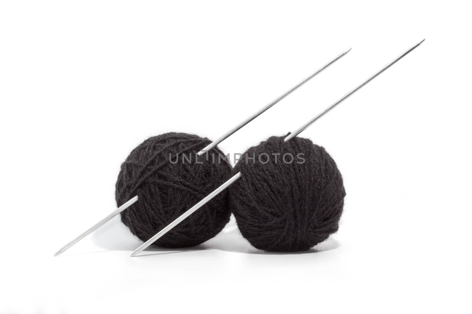 balls of yarn and knitting needles isolated