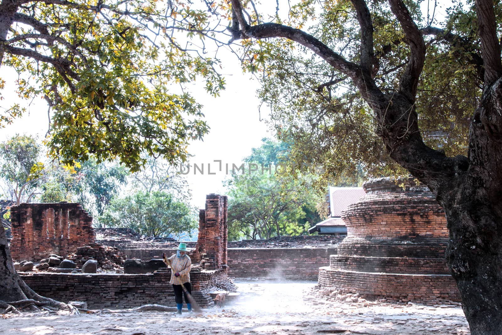 worker sweeper cleaning ancient temple with broom tool