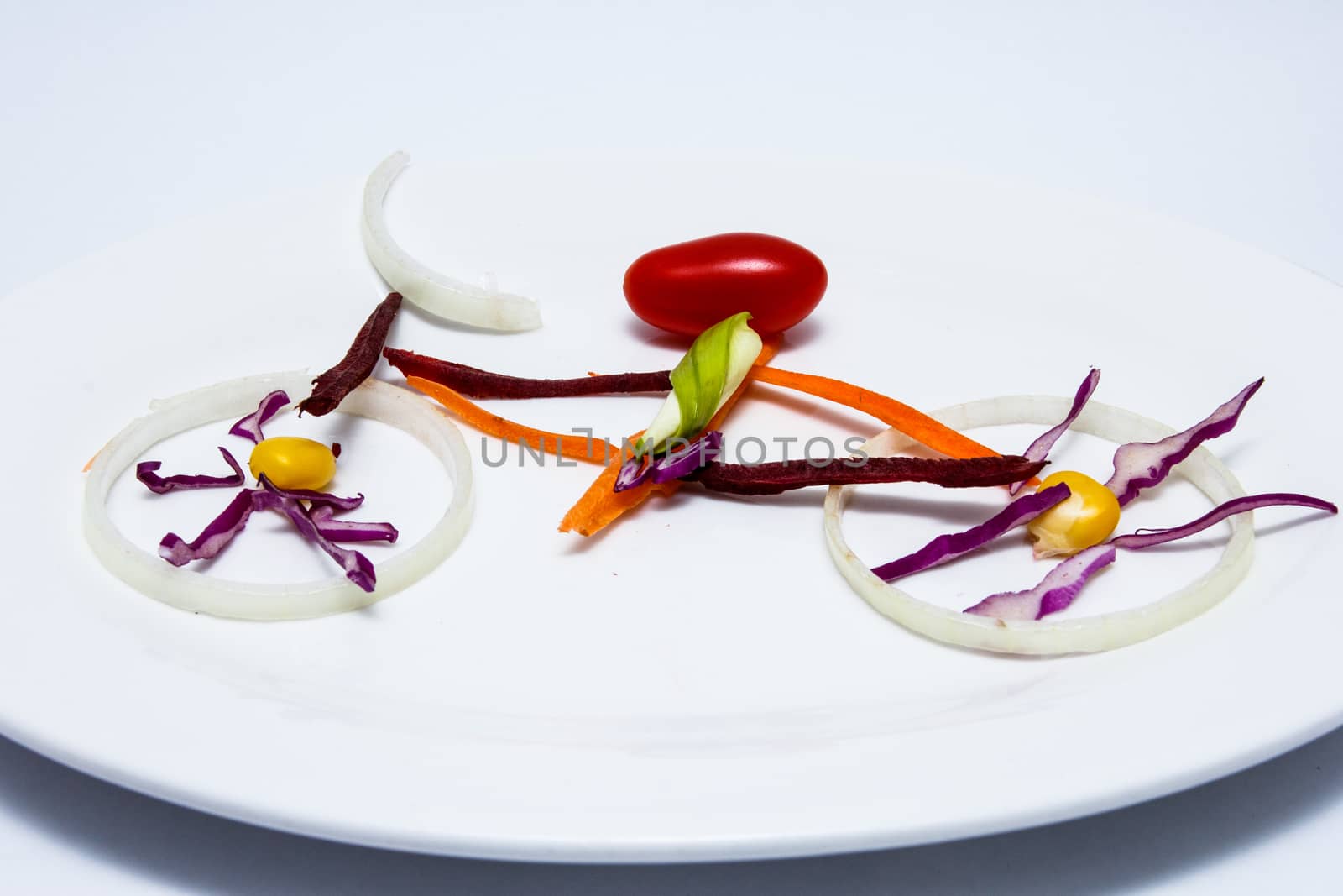 Sliced vegetables in form of a bicycle on dish by kannapon