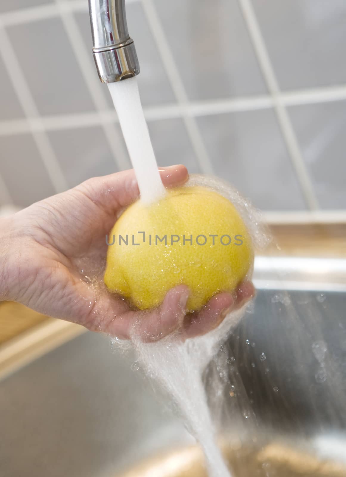 Close up of washing a lemon