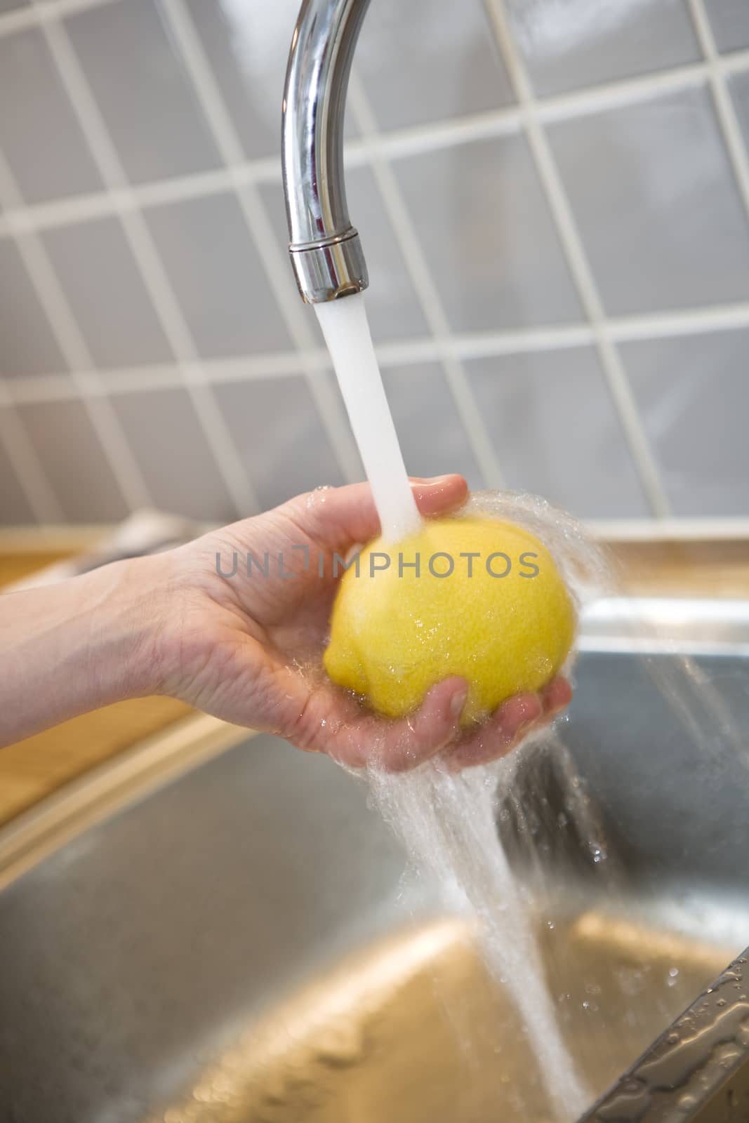 Close up of washing a lemon