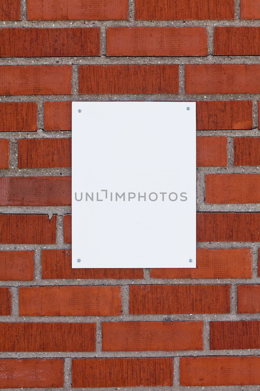 Brick wall with a blank sign