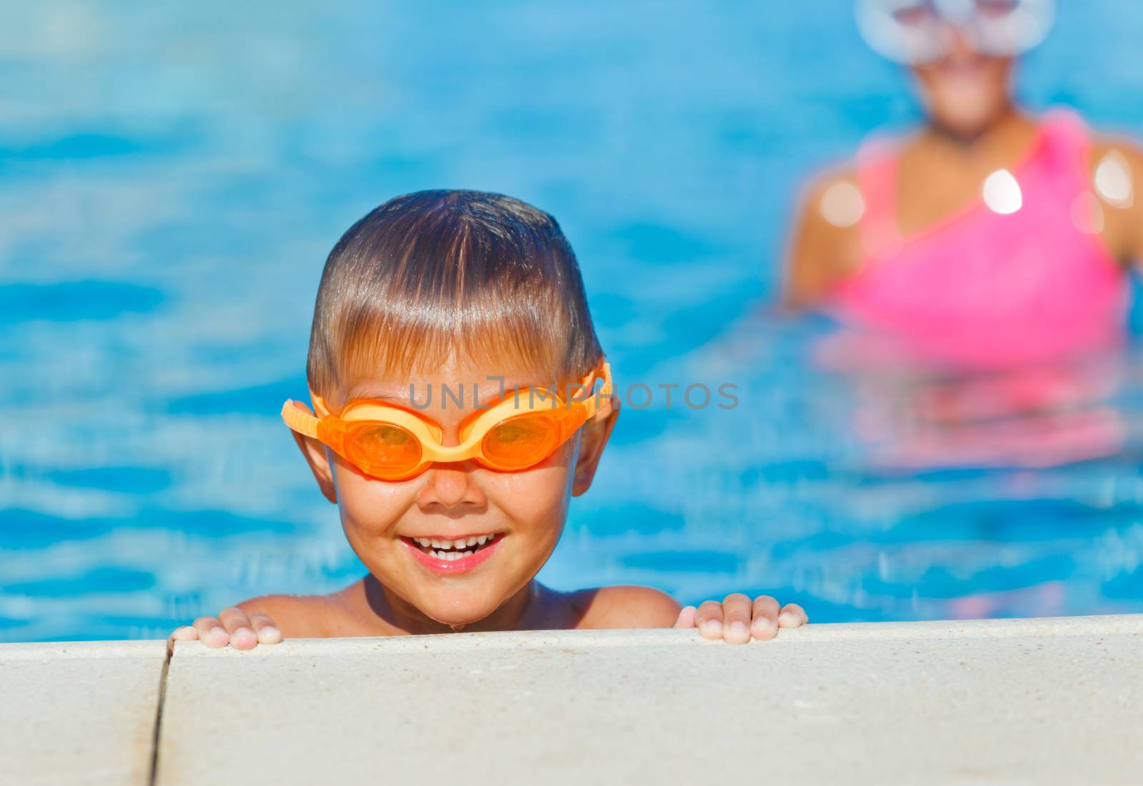 Activities on the pool. Cute boy in swimming pool