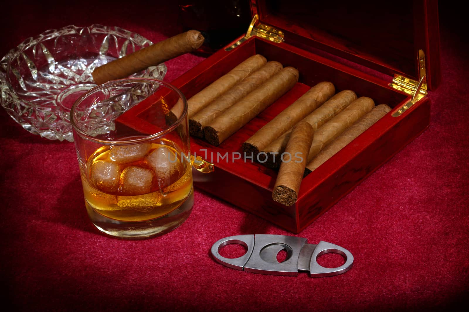 cigars in the box and glass with whisky, close up shallow dof 