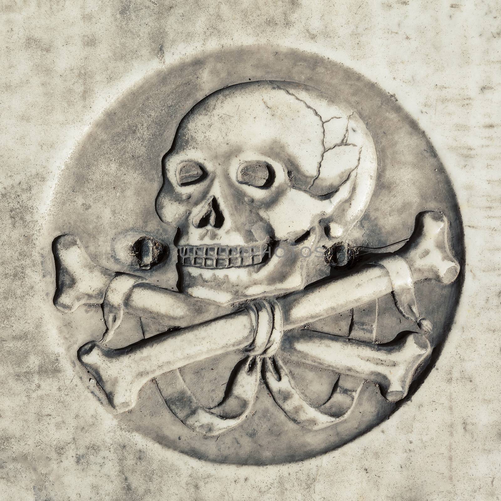 Skull in ancient tomb cemetery, and death symbol 