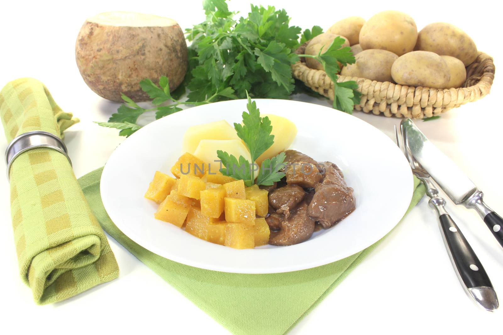 Venison goulash with turnip and potatoes on a light background