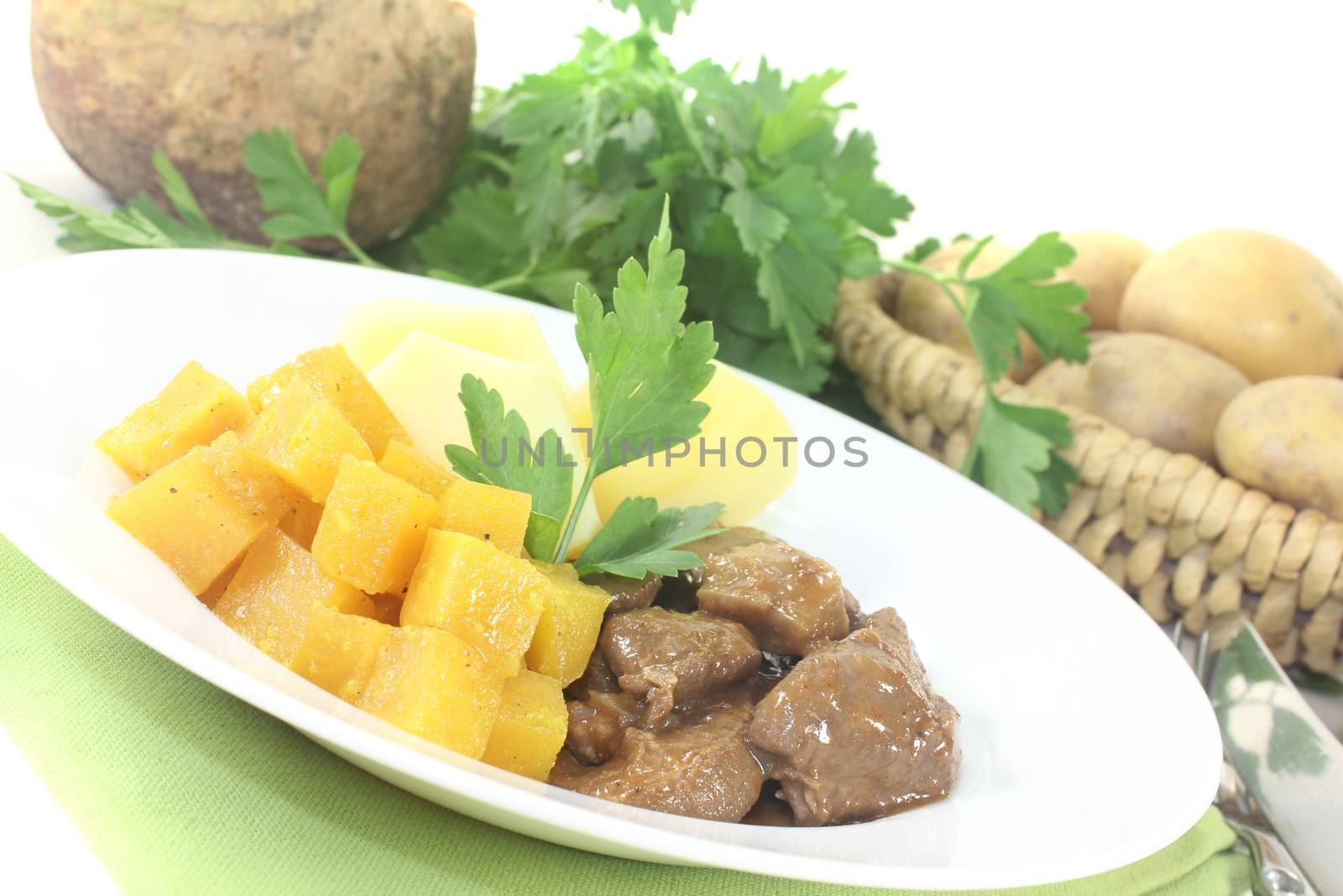 Venison goulash with turnip on a light background
