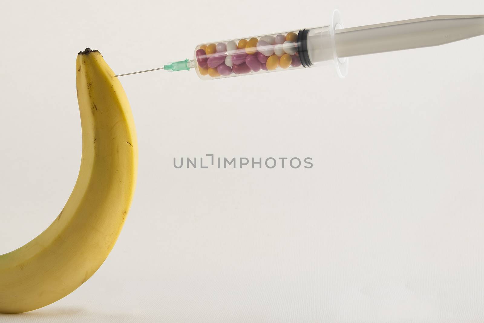 Male impotence metaphor: banana and syringe with pills