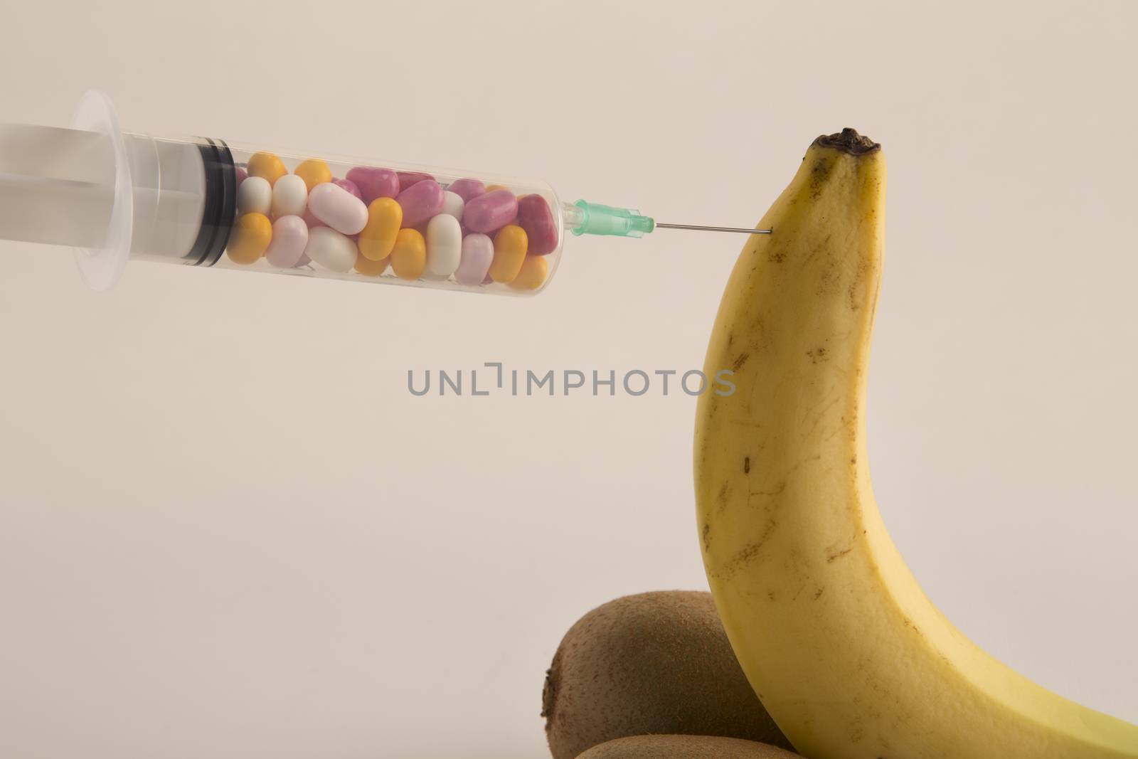 Male impotence metaphor: banana,kiwi and syringe with pills