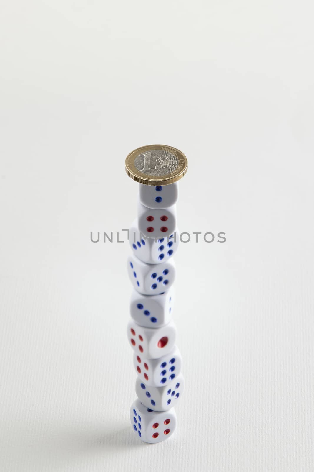 euro coin on dice stack