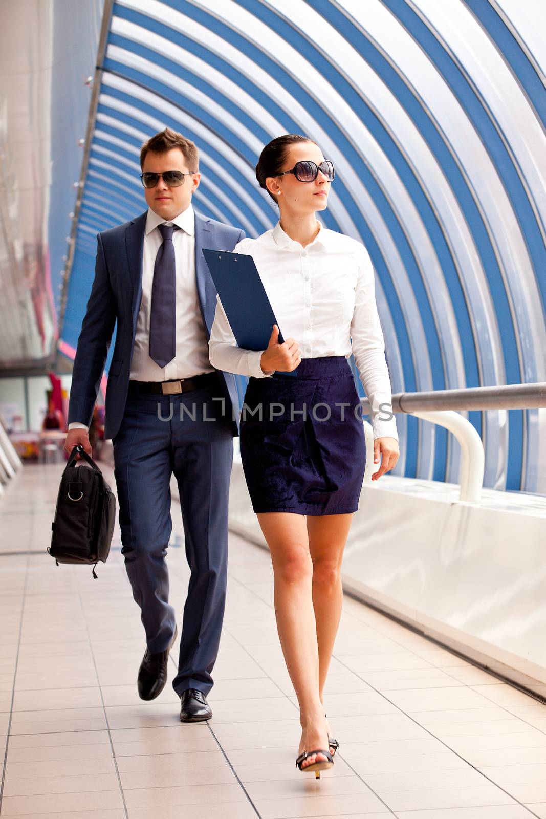 businesswoman and a bodyguard go to a business meeting