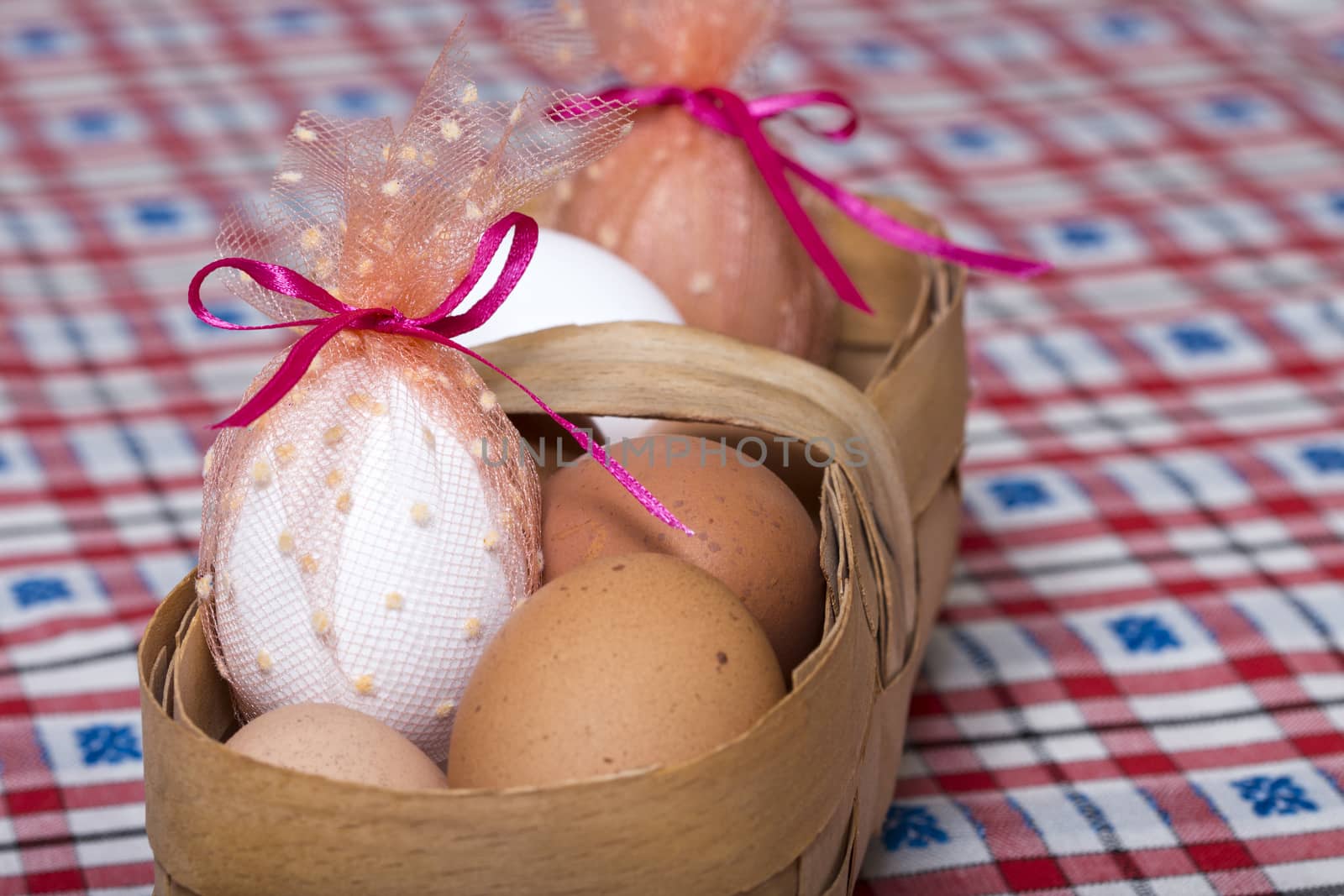 Easter eggs in the basket on the tablecloth