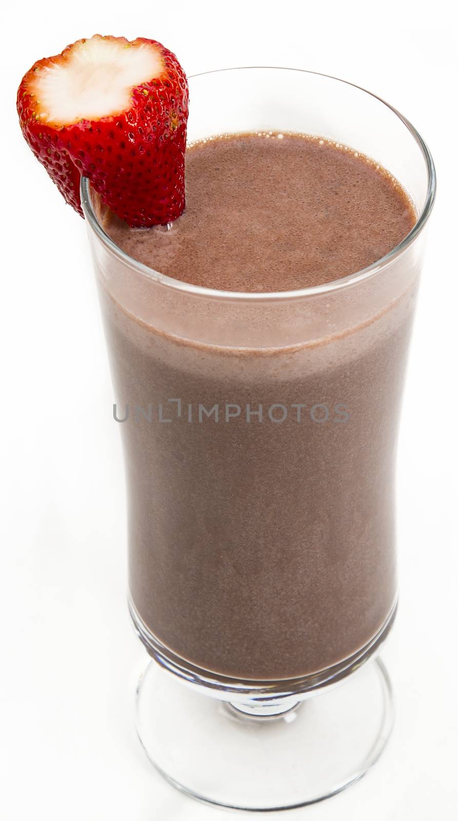 Chocolate milkshake with a strawberry on the side against a white background