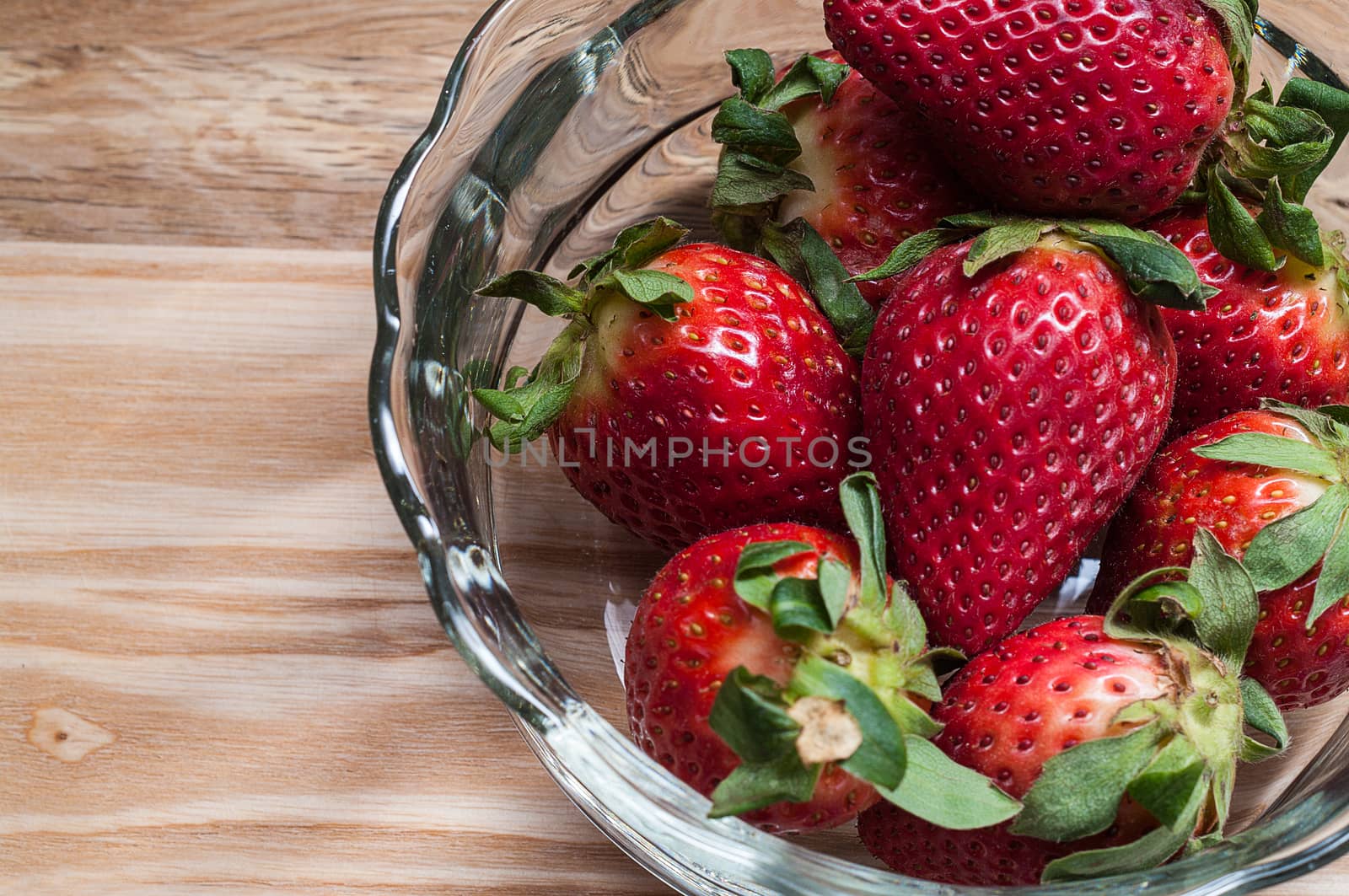 Strawberries in a glass bowl by edcorey