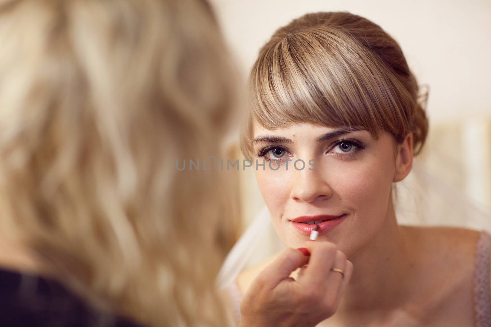 girl applying make-up by vsurkov