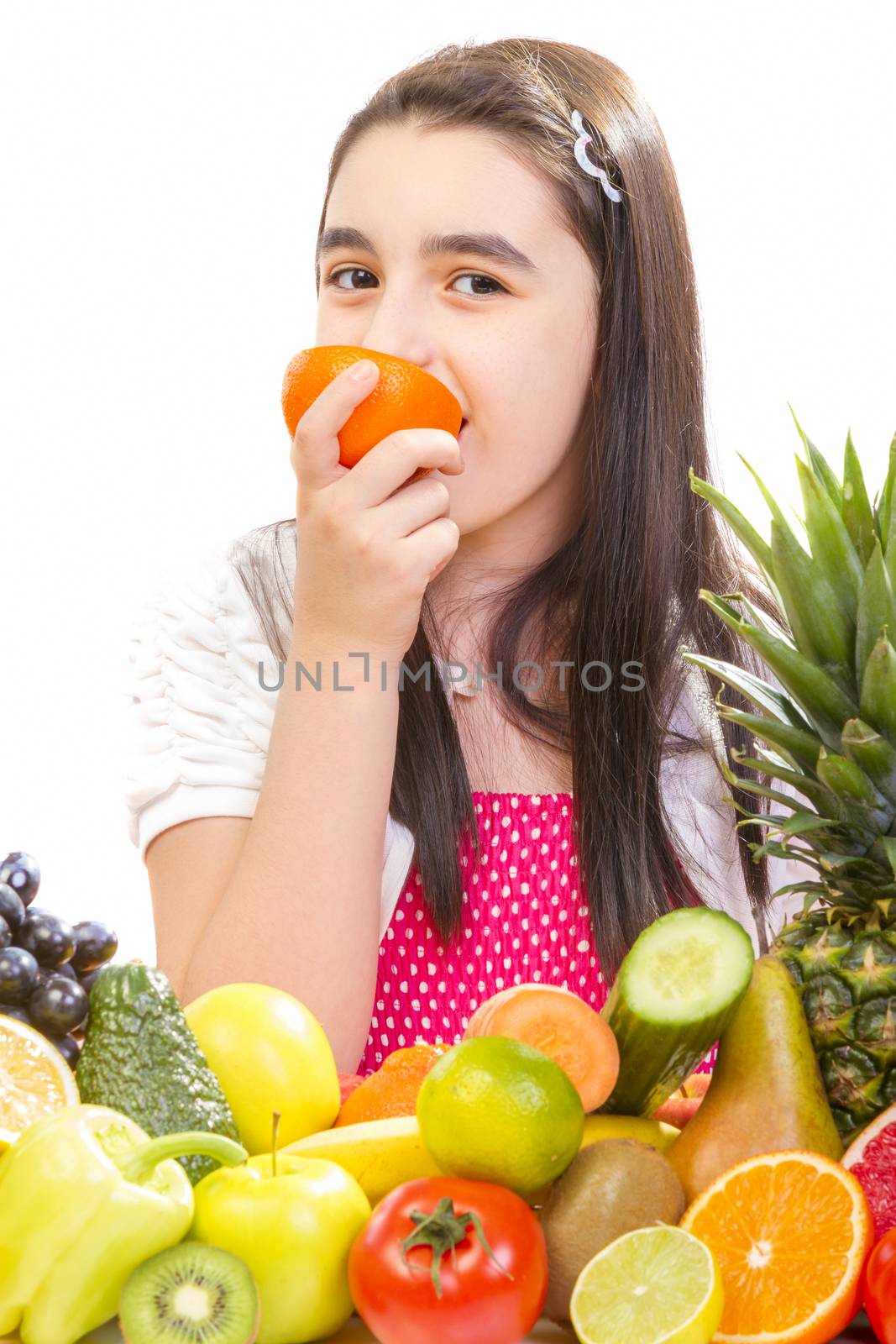 Little girl with fruits - Happy girl with fruits assortment on the table.
