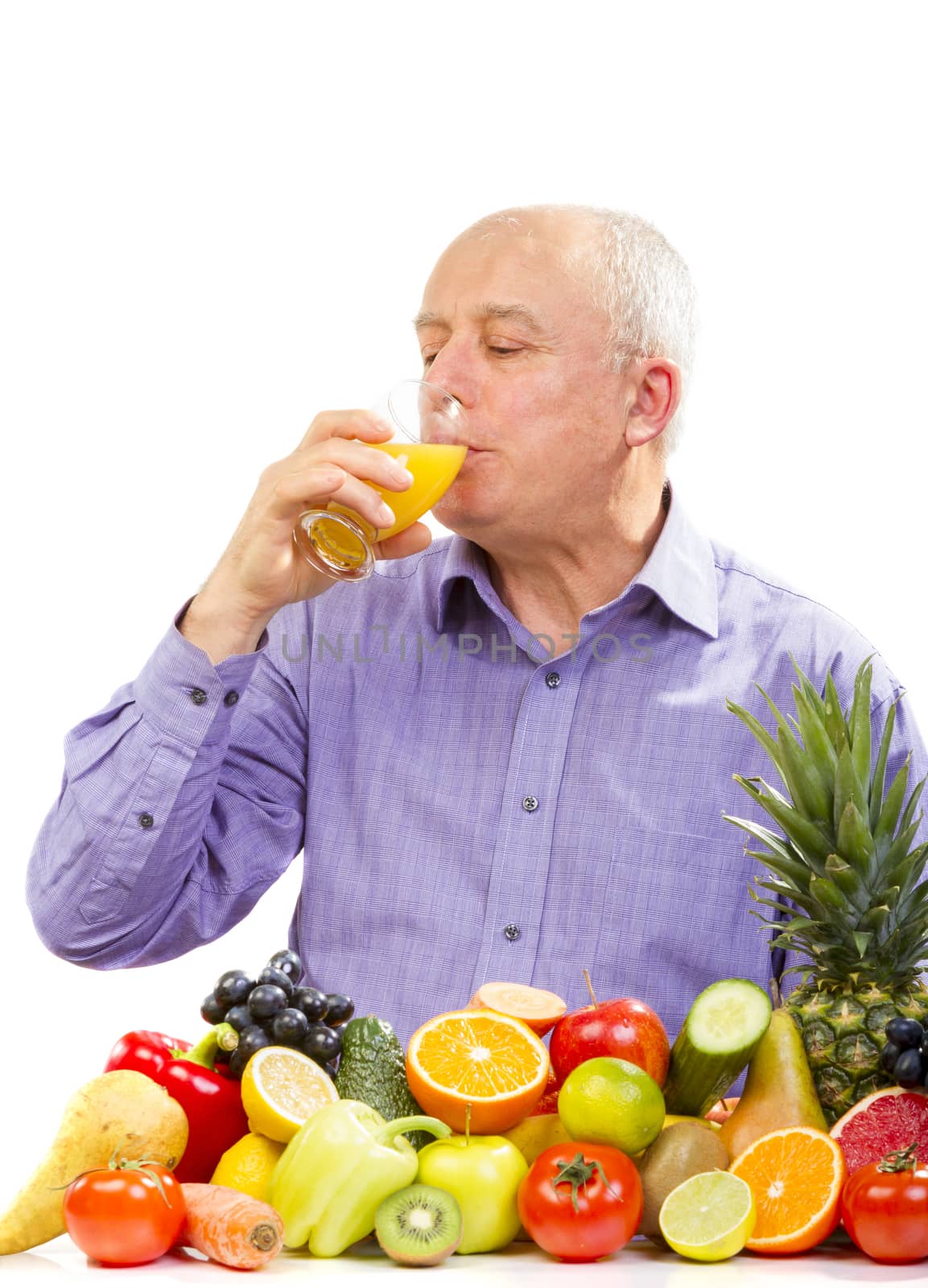 mature man  juice and standing next to fruits and vegetables isolated on white