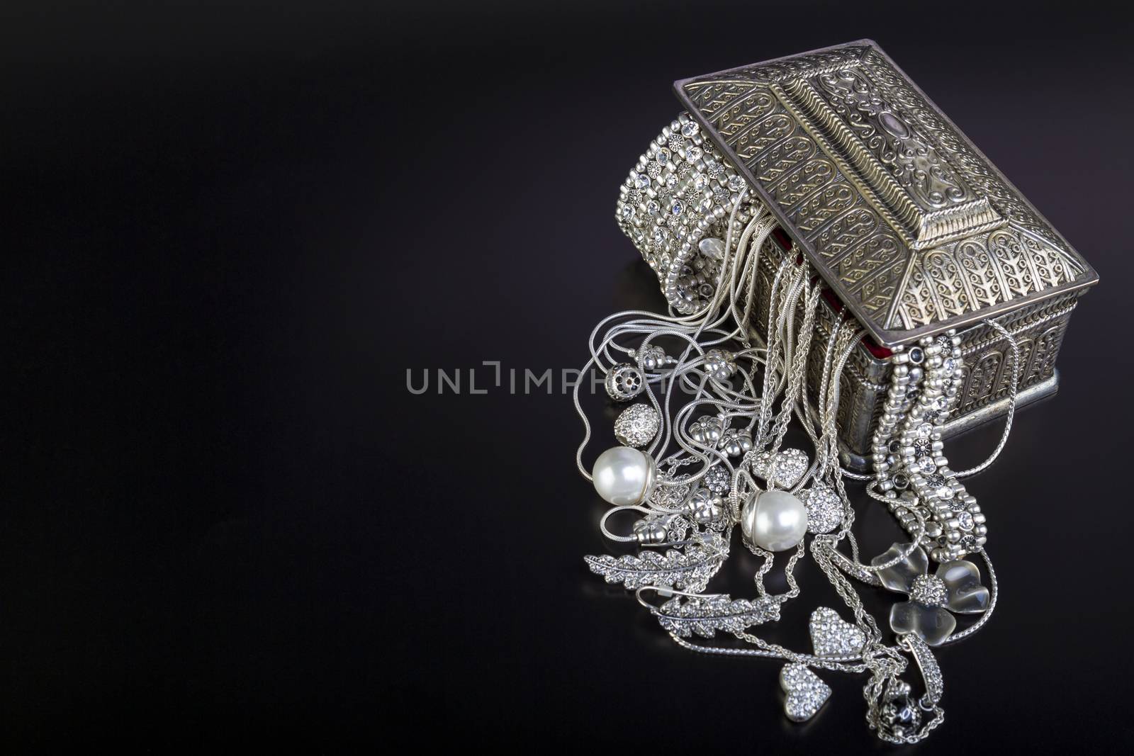 Silver jewelry on black by manaemedia