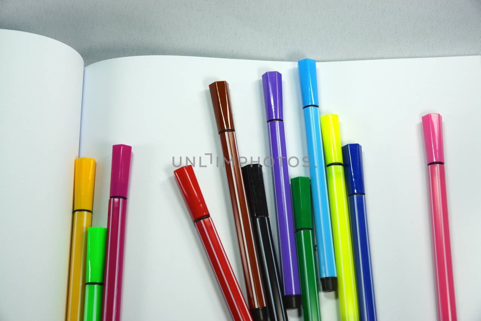 colourful magic pens and drawing book,shallow focus