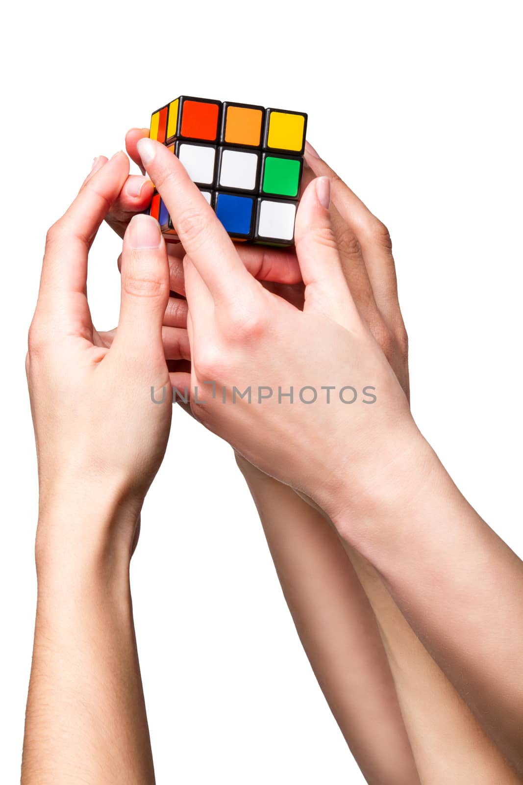 Hands holding color cube on white background