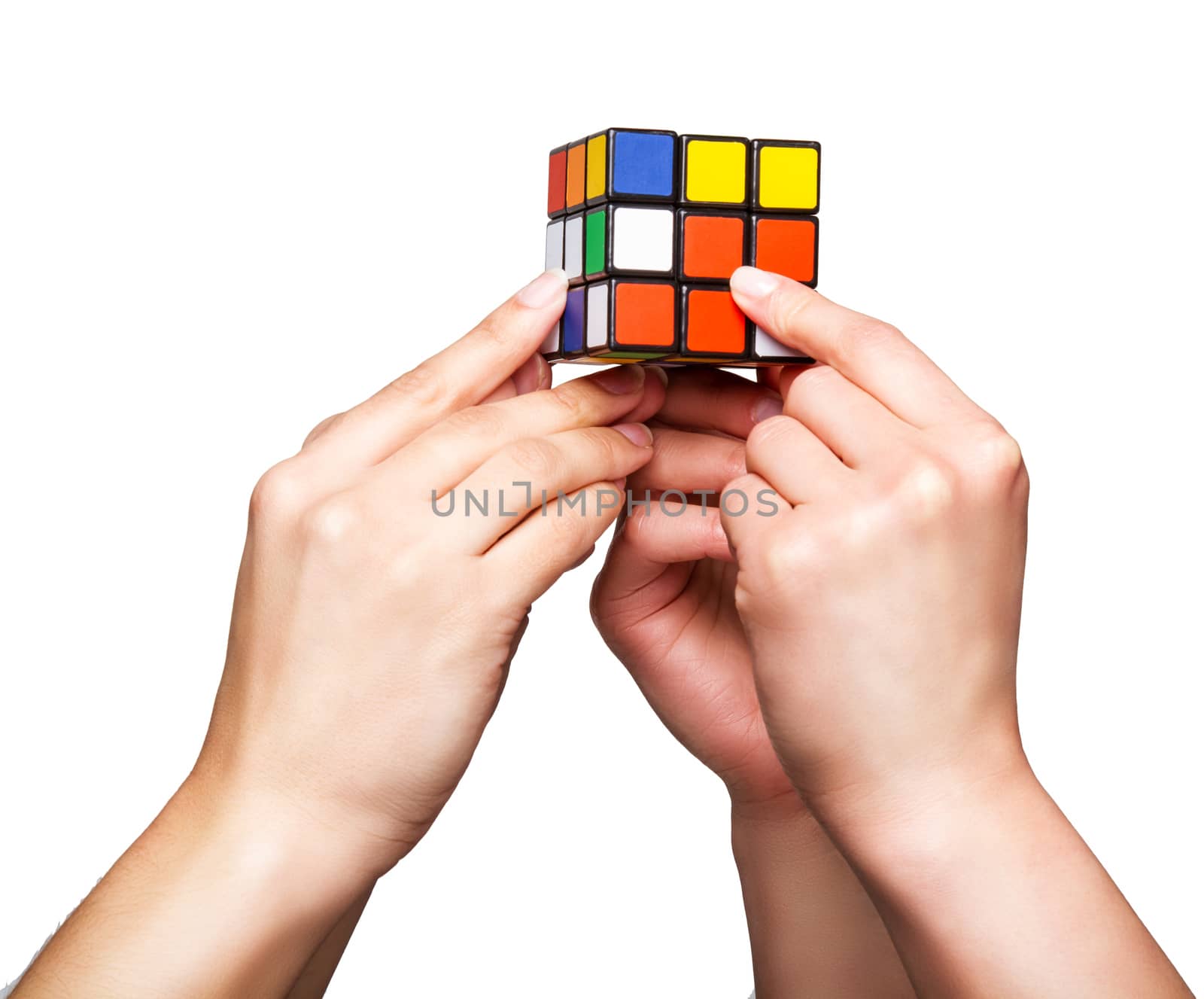 Hands holding color cube on white background