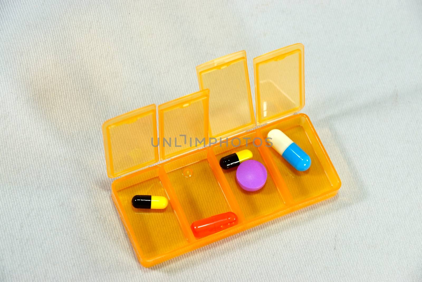 colourful pills box by nattapatt