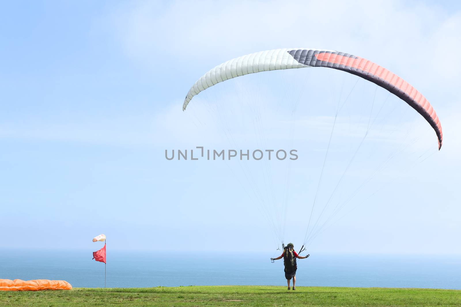 LIMA, PERU - FEBRUARY 20, 2012: Unidentified person taking off with a paraglider on the coast of Miraflores on February 20, 2012 in Lima, Peru. Paragliding is a popular sport on the coast of Miraflores, where winds are usually good and in good weather a big part of the coast of Lima can be seen. 