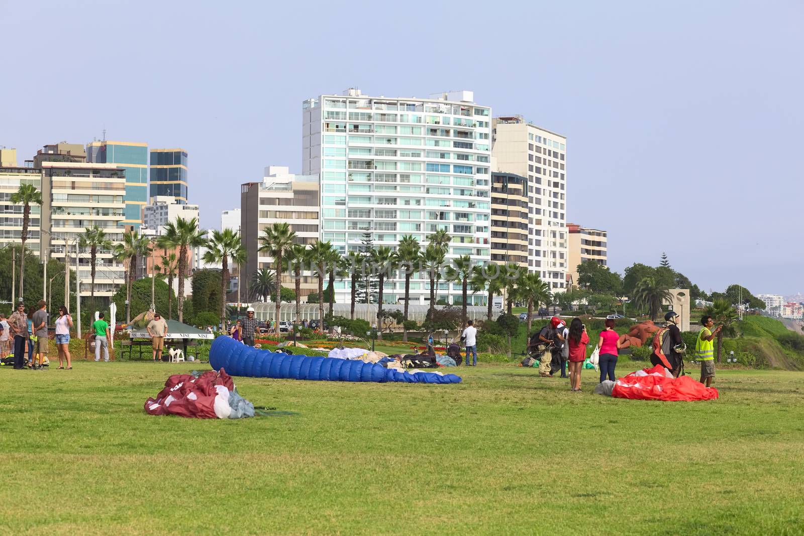 LIMA, PERU - MARCH 19, 2012: Unidentified people with paragliders on the coast of Miraflores on March 19, 2012 in Lima, Peru. Paragliding is a popular sport on the coast of Miraflores, where winds are usually good and in good weather a big part of the coast of Lima can be seen. 