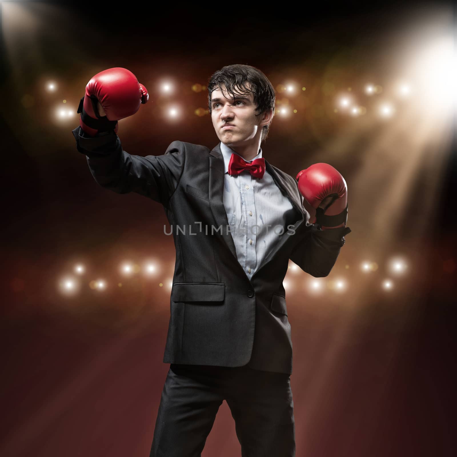 image of a businessman with boxing gloves in the ring, the competition in the business