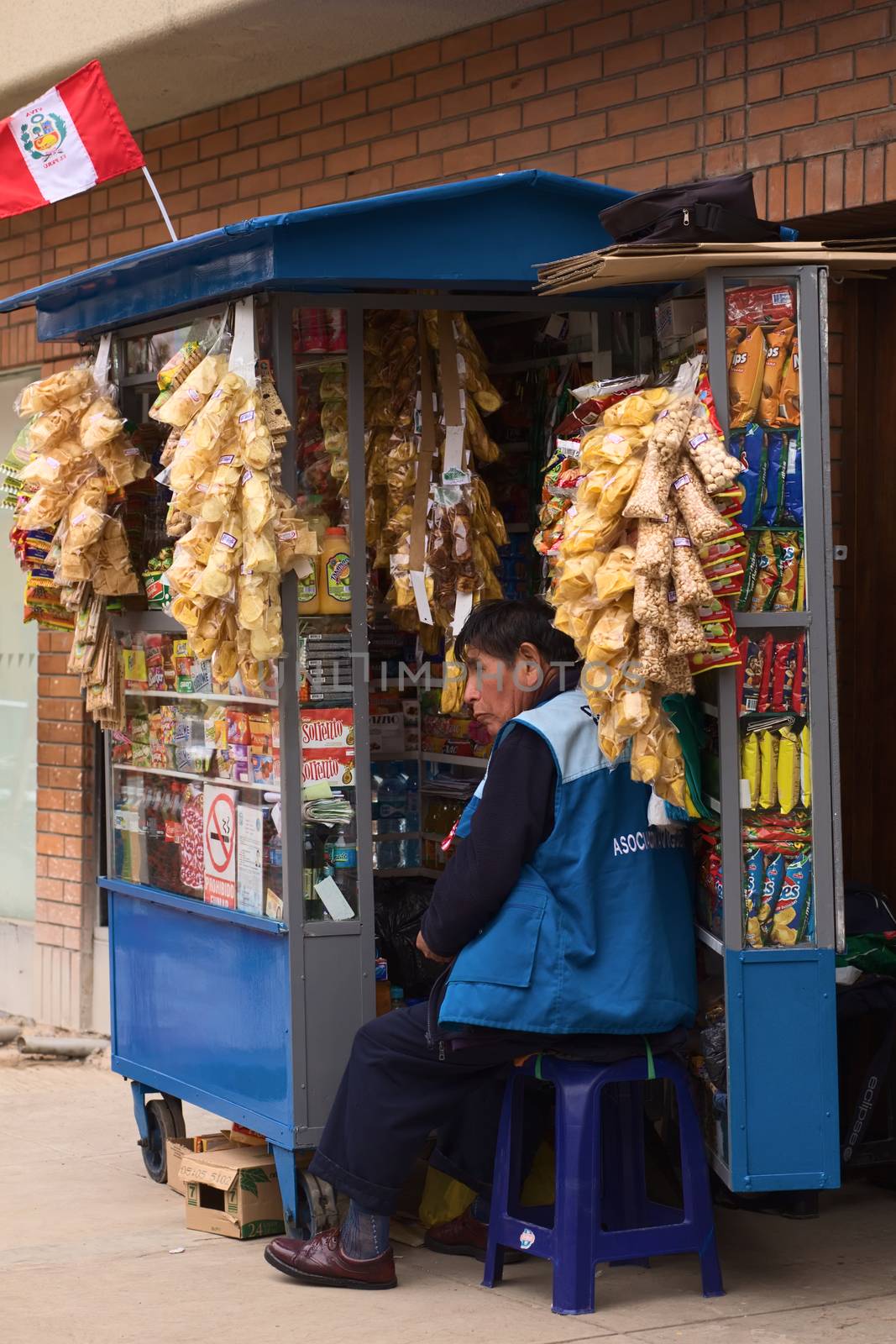 LIMA, PERU - JULY 23, 2013: Unidentified street vendor selling snacks and drinks at a stand on July 23, 2013 in Miraflores, Lima, Peru. These snack stands are a very common sight all over Lima. 