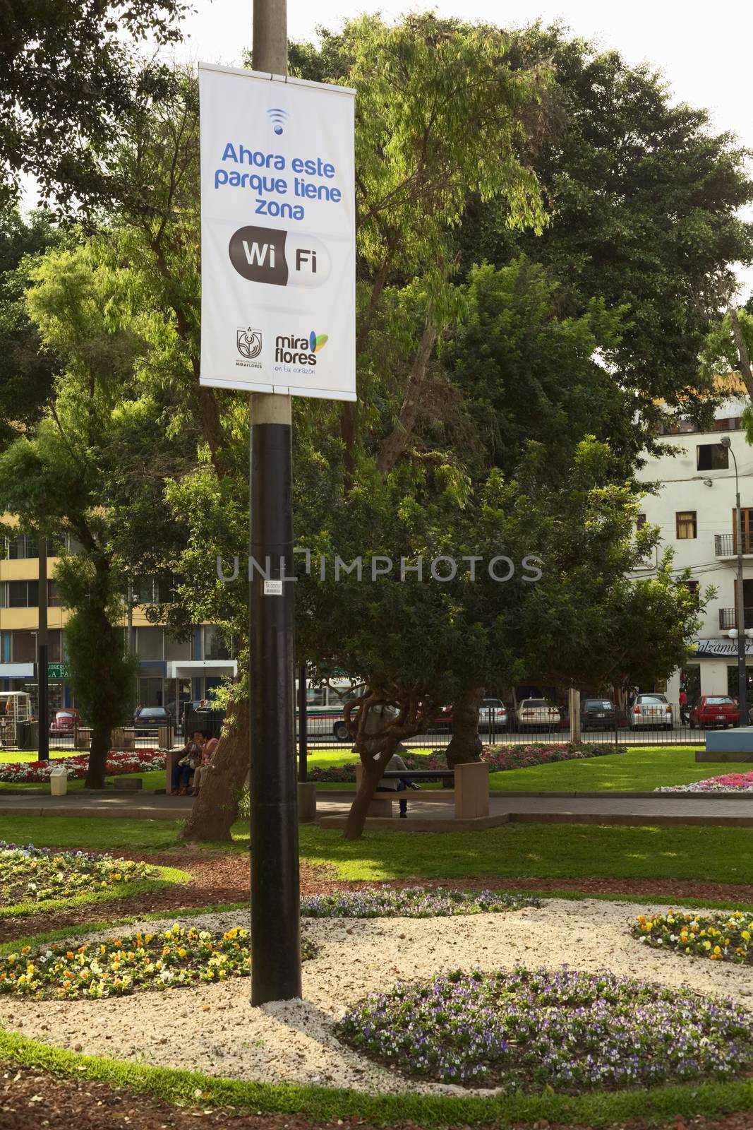 LIMA, PERU - DECEMBER 13, 2011: Wifi-Zone sign with unidentified people in the back in the Kennedy Park in the district of Miraflores on December 13, 2011 in Lima, Peru. Miraflores is one of the most modern districts of Lima, where the municipality invests in the improvement of public spaces.