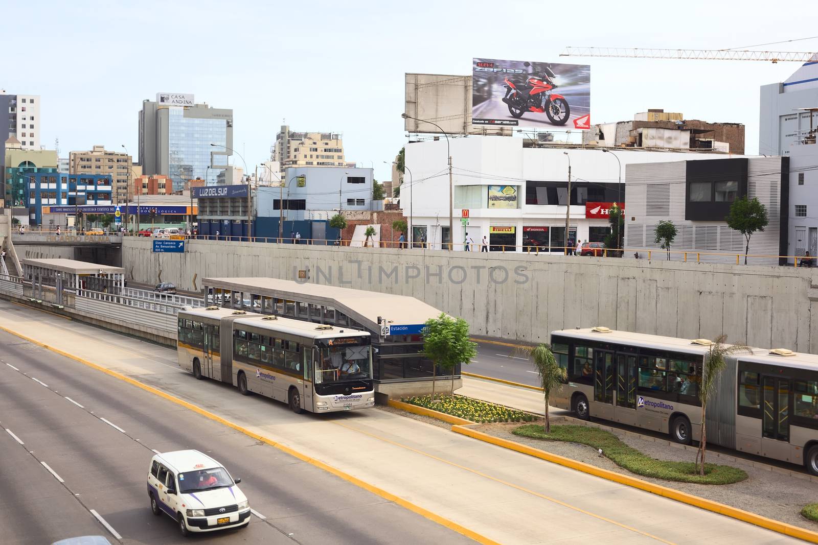 LIMA, PERU - FEBRUARY 13, 2012: Metropolitano bus of the Line A stopping at the crossing of the Avenues Ricardo Palma and Paseo de la Republica in Miraflores on February 13, 2012 in Lima, Peru. The Metropolitano is a Bus rapid transit system operating since 2010 in Lima running from North to South.