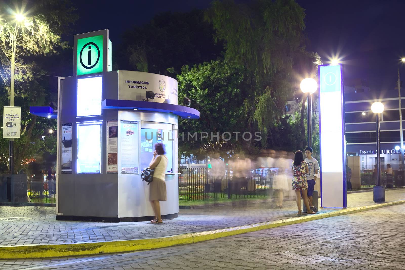 LIMA, PERU - MARCH 5, 2012: Unidentified person at the tourist information at Kennedy Park in the district of Miraflores in the evening on March 5, 2012 in Lima, Peru. Miraflores is the most touristy district of Lima, which has the most infrastructure for tourism.  