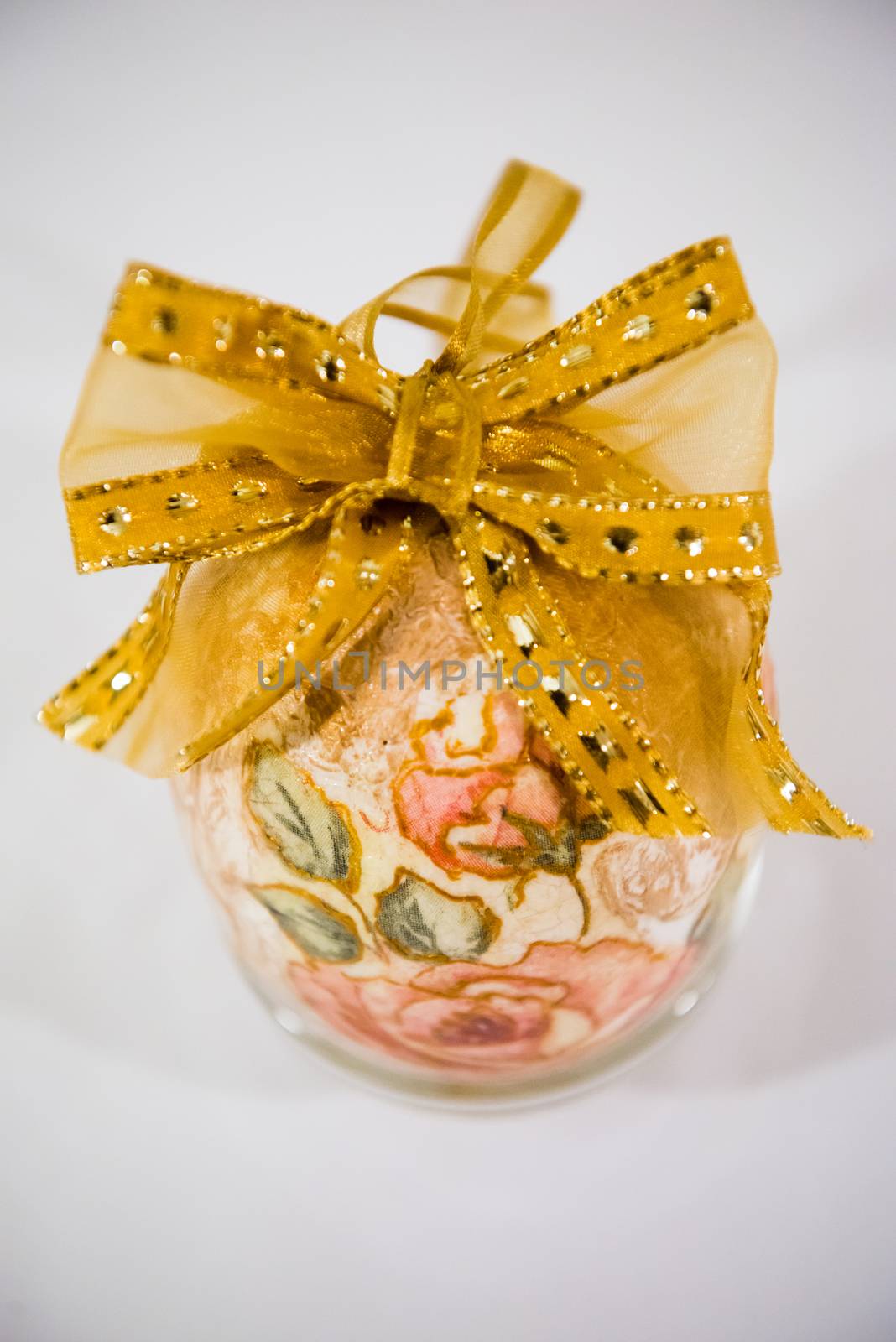 Easter egg decorated with flowers made by decoupage technique on light background