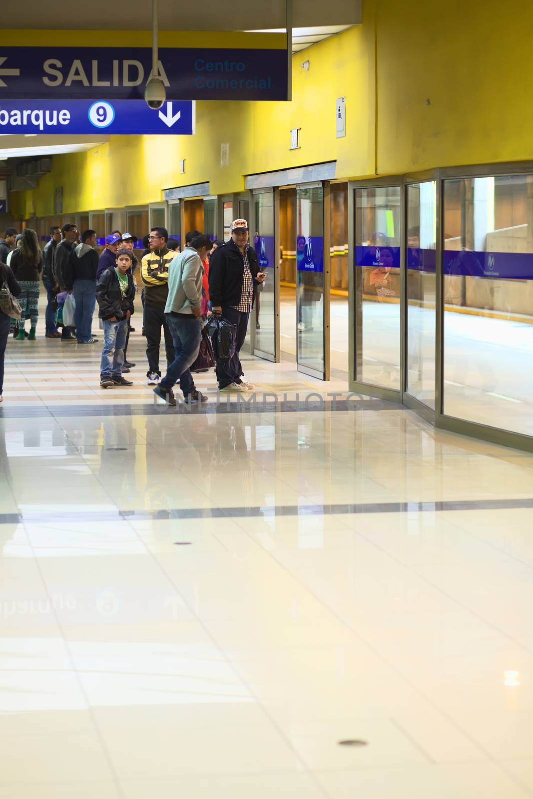 LIMA, PERU - JULY 21, 2013: Unidentified people waiting for the Metropolitano bus at the central bus station on July 21, 2013 in Lima, Peru.  The Metropolitano is a Bus rapid transit sytem operating since 2010 in Lima running from North to South.