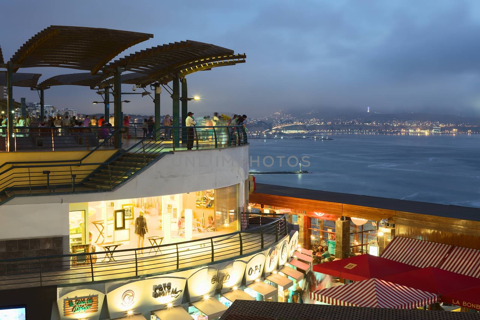 LIMA, PERU - MARCH 11, 2012: Unidentified people enjoying the view over the Pacific coast at the shopping mall Larcomar in Miraflores in the evening on March 11, 2012 in Lima, Peru. Larcomar is a popular mall on the coast, here with view over the coast of the district of Chorrillos to the South.