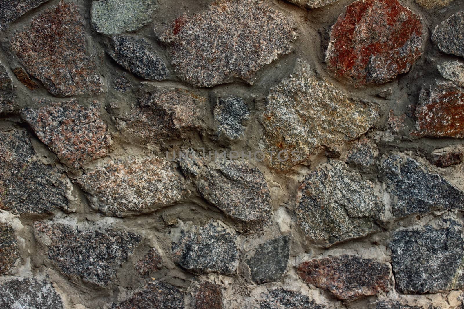 rocky wall whose stones of different colors and different shapes