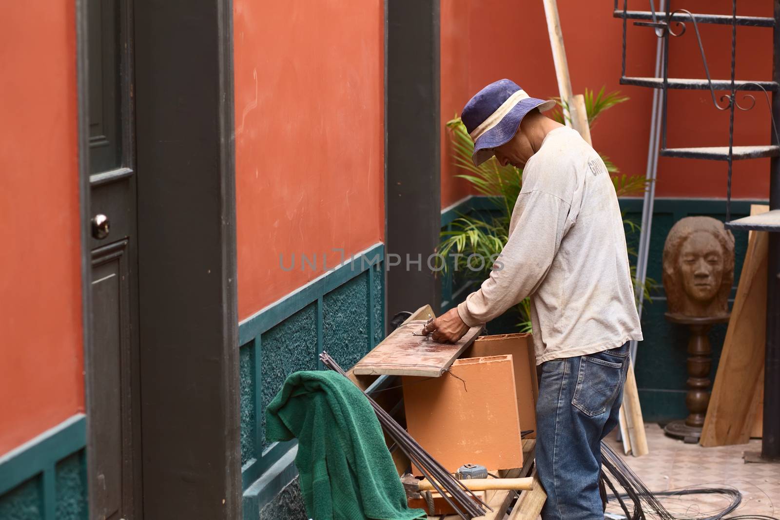 LIMA, PERU - MARCH 8, 2012: Unidentified construction worker bending steel for steel concrete column in Miraflores on March 8, 2012 in Lima, Peru.