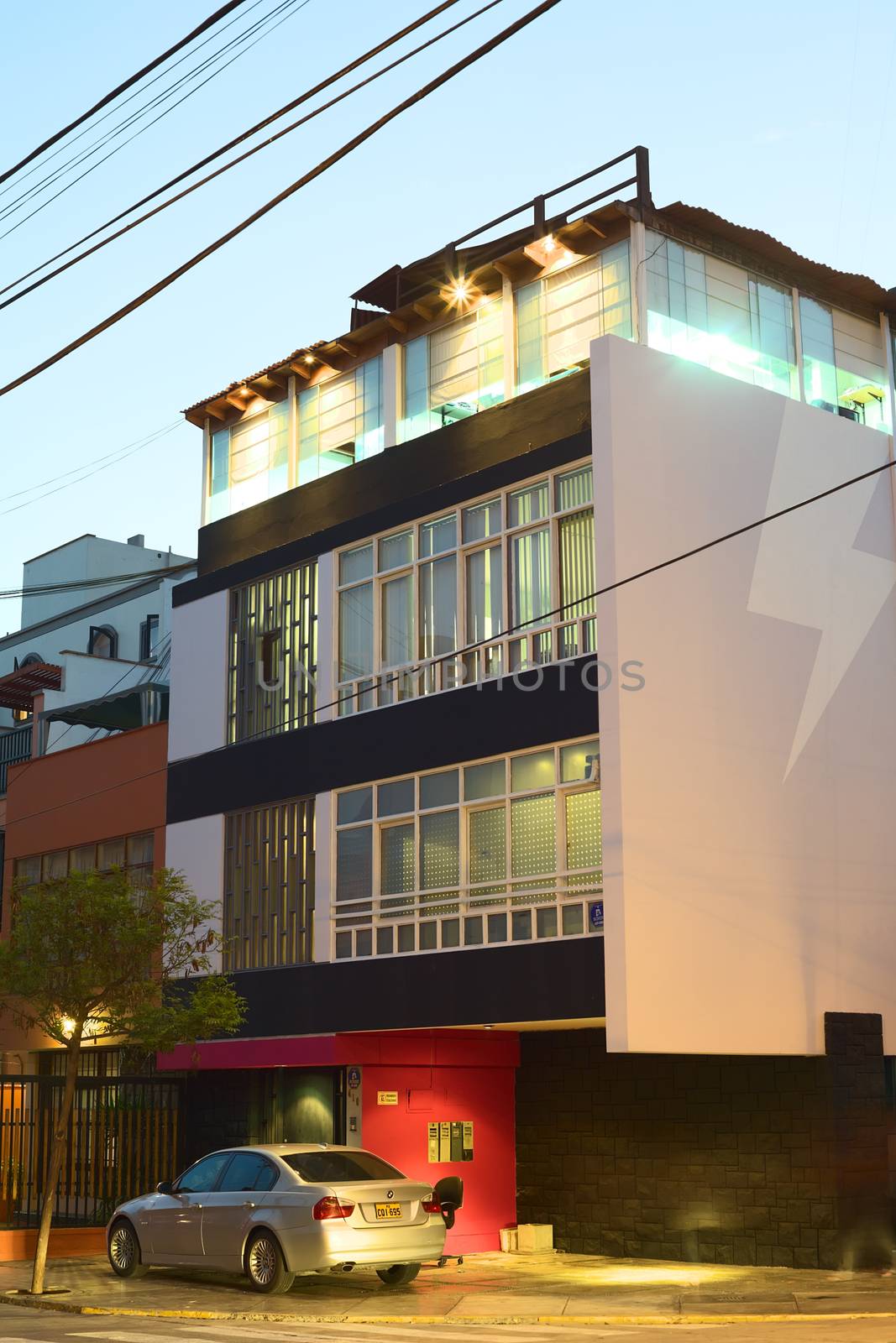 LIMA, PERU - MARCH 29, 2012: Modern building in the evening in a street in Miraflores on March 29, 2012 in Lima, Peru. Miraflores is one of the most modern districts of Lima.  