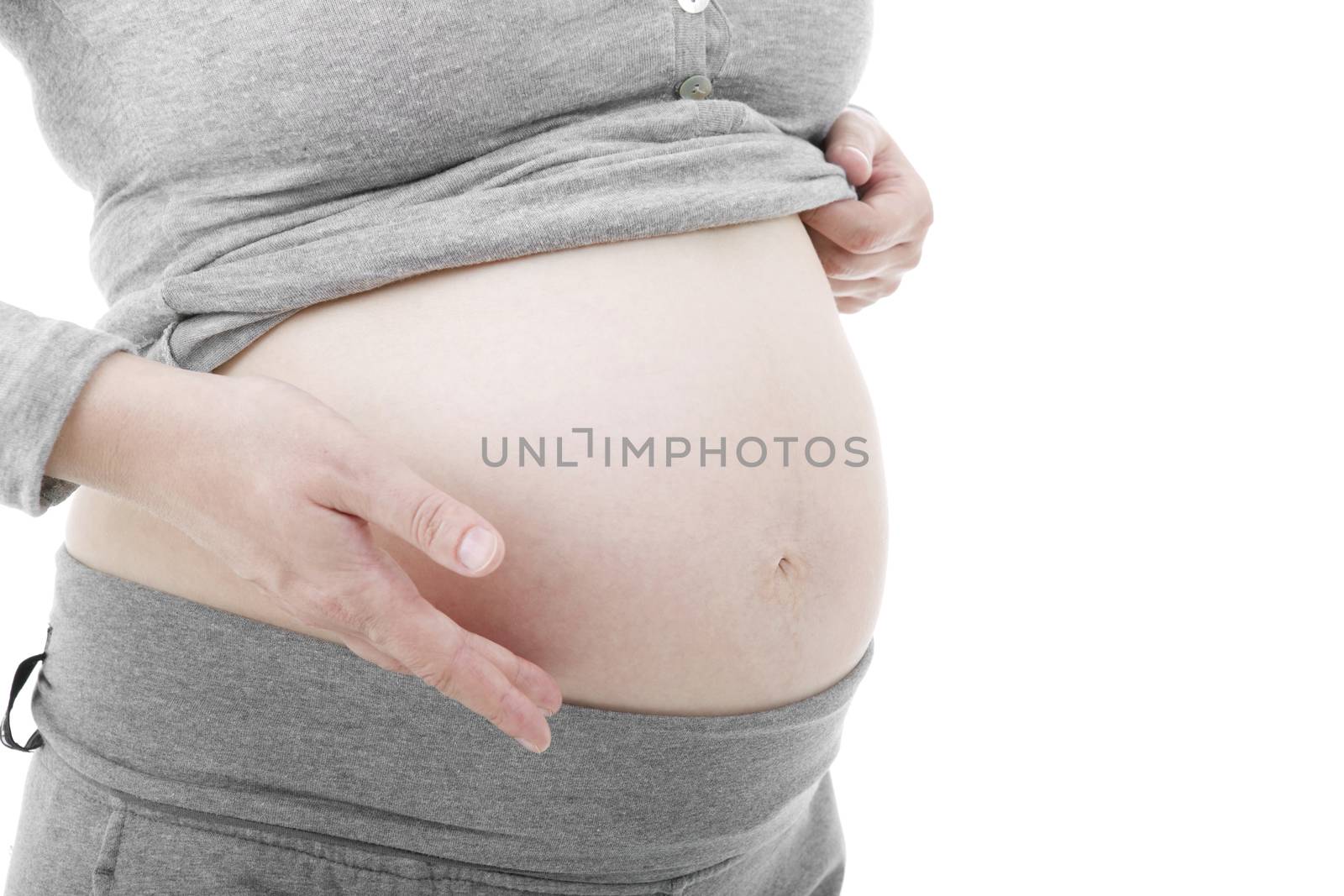 Closeup of pregnant woman at white background