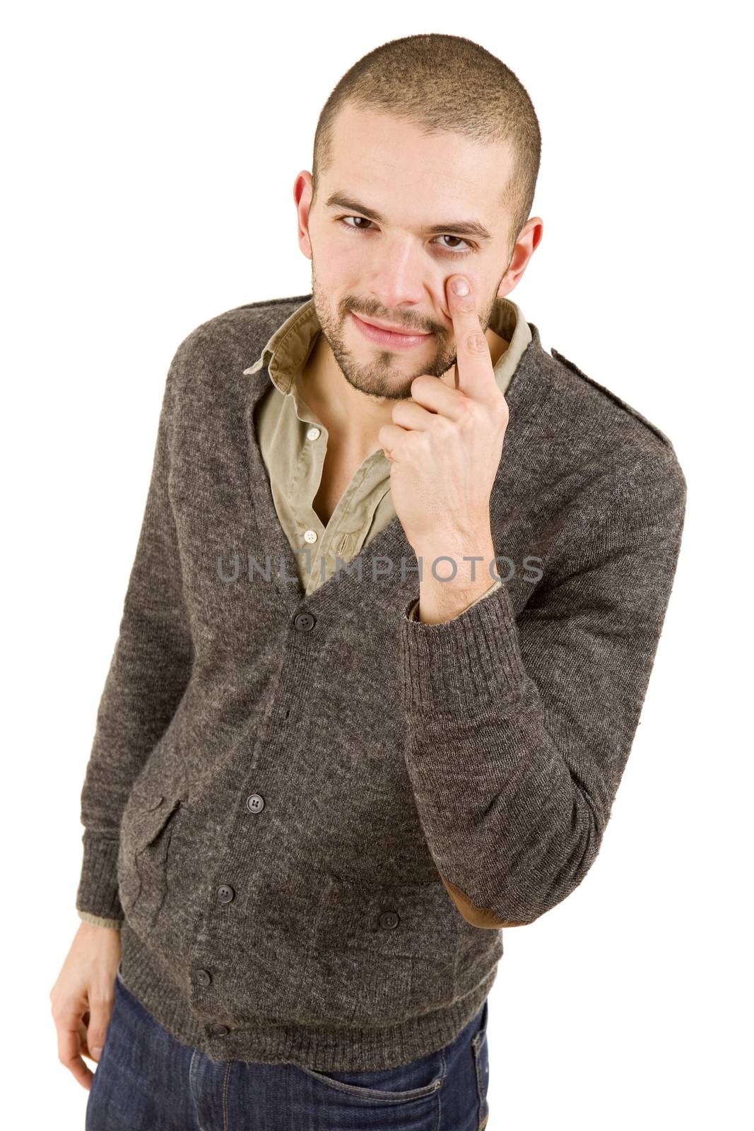 young casual man pointing to his eye, isolated on white