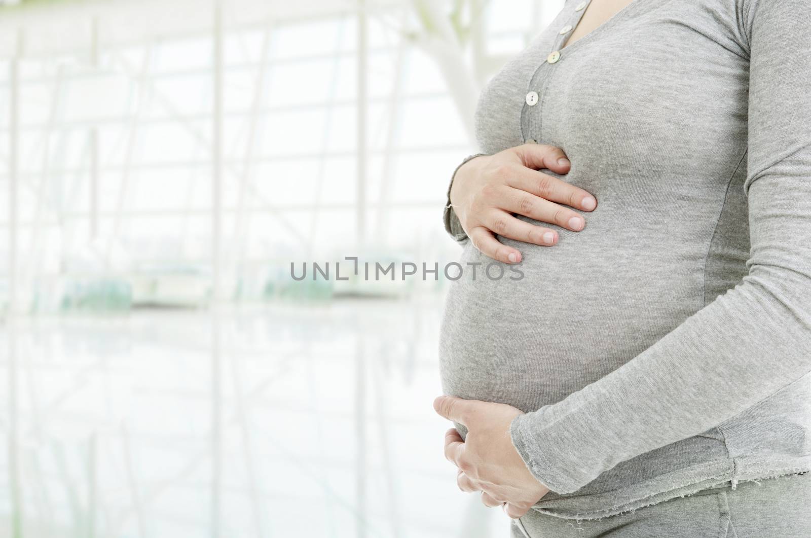 Closeup of pregnant woman at white background