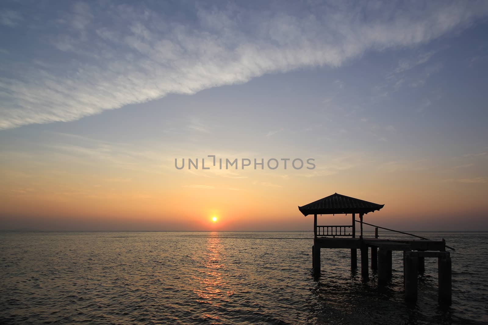  Silhouette of old pavilion in the sea at sunset