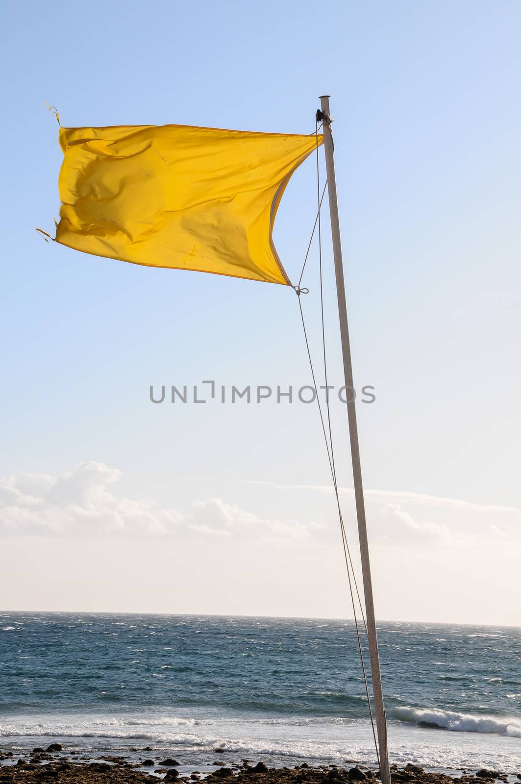 Yellow Festive Flag Waving In The Wind Tenerife Canry Island Spain