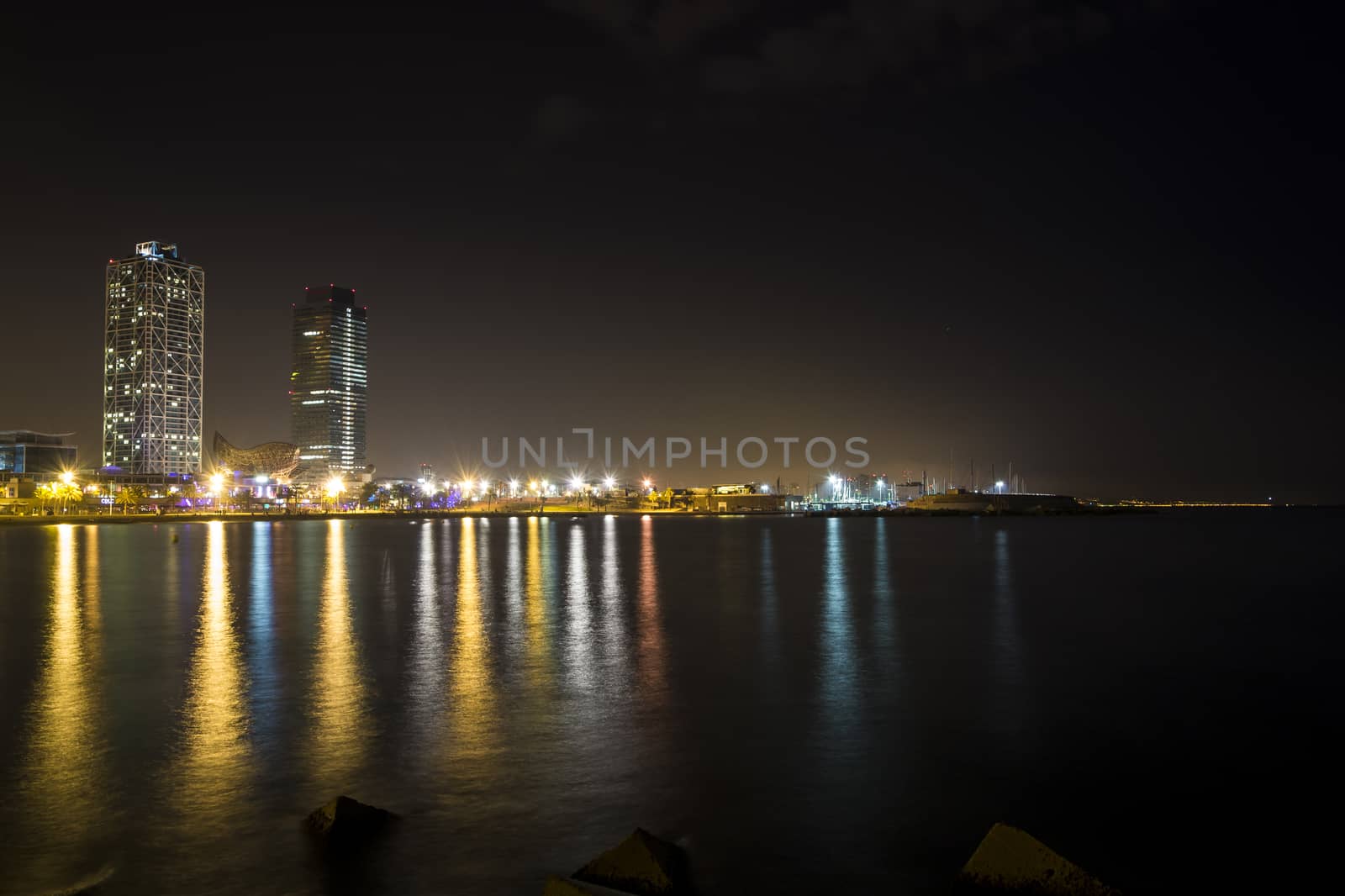 View of the promenade of Barcelona by night from the sea