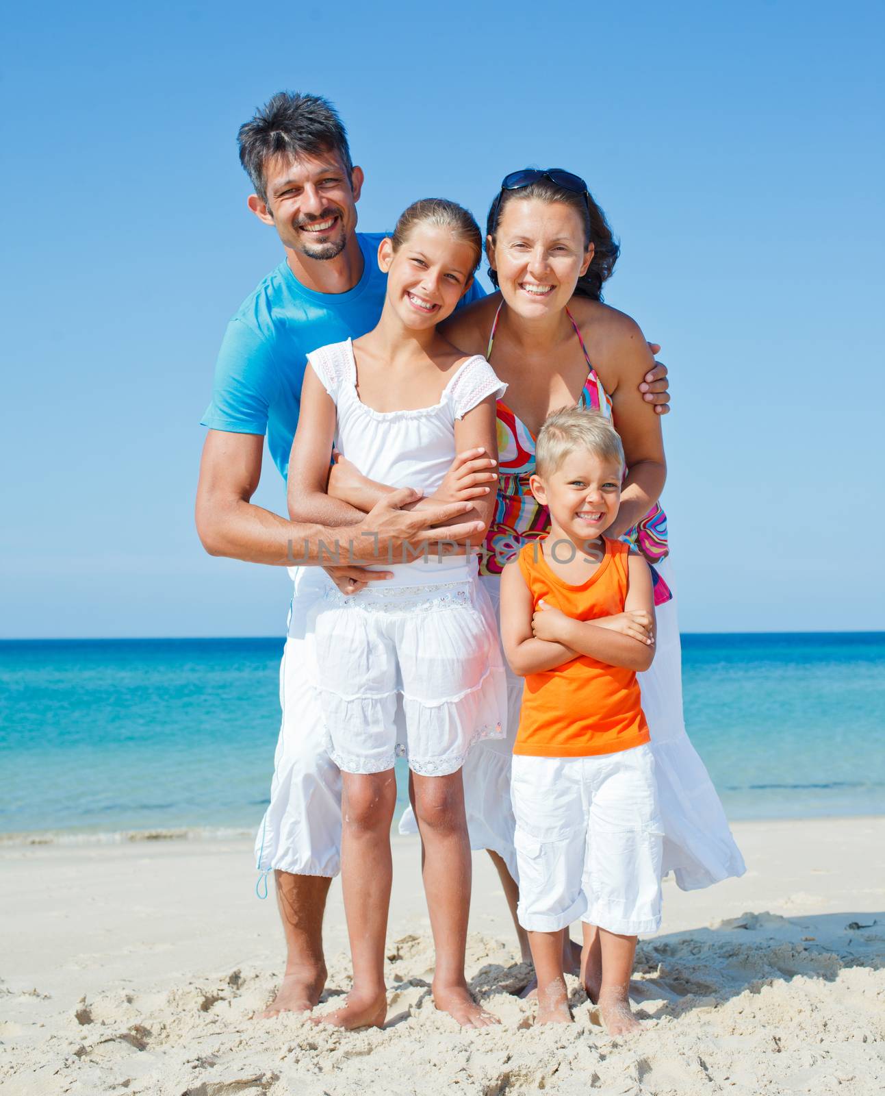 Family on tropical beach by maxoliki