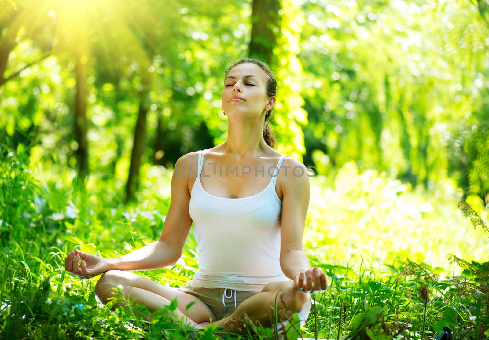 Young Woman doing Yoga Exercises Outdoor by SubbotinaA